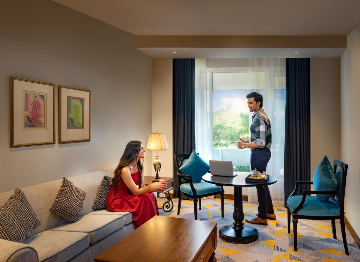 a man and a woman standing in a living room at Welcomhotel by ITC Hotels, Cathedral Road, Chennai in Chennai