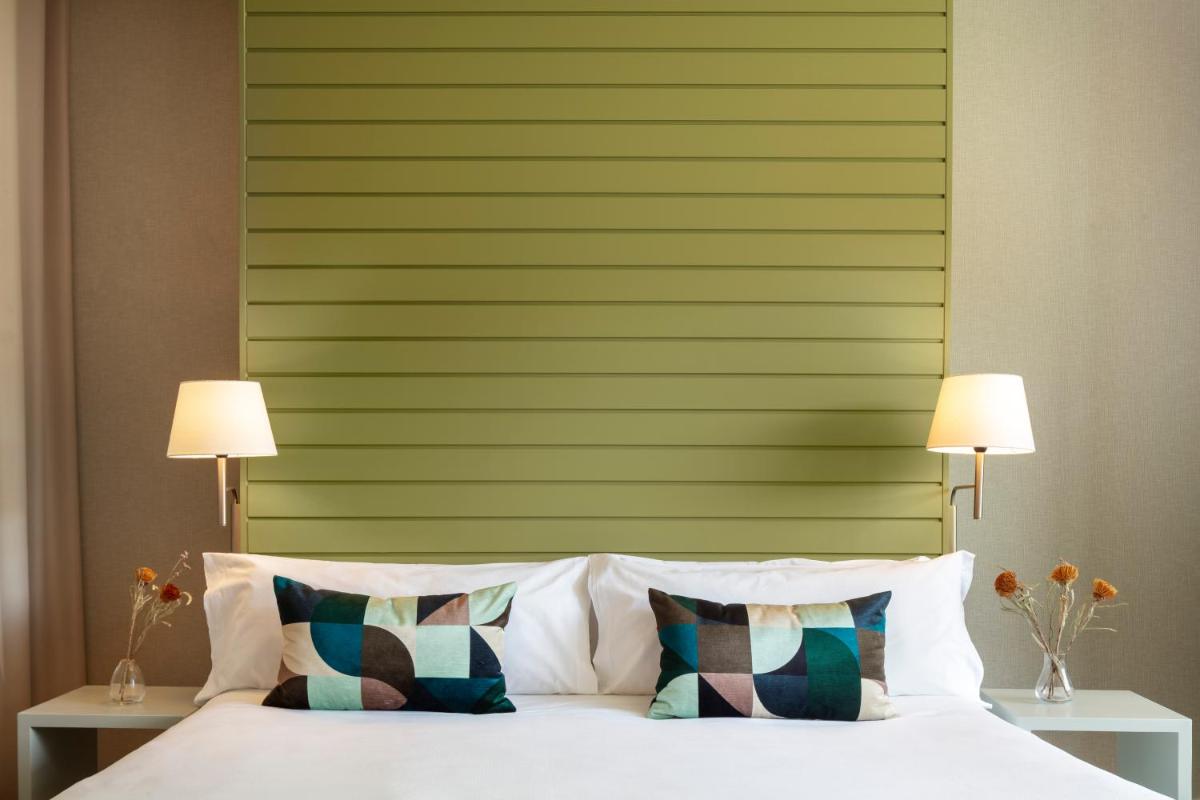 Cama o camas de una habitación en Hotel Miró