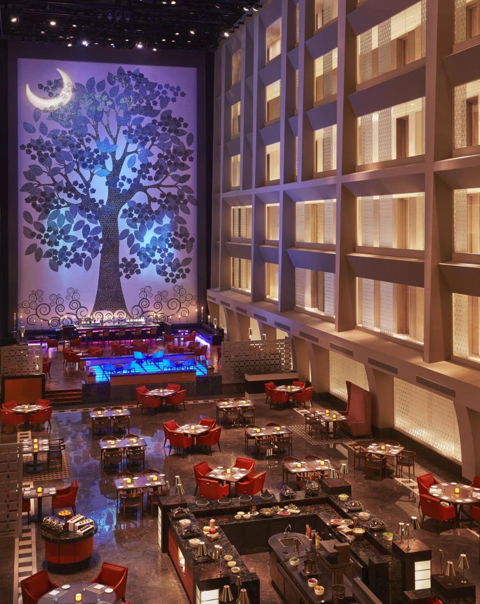 a rendering of a restaurant with a tree on the wall at Taj Santacruz in Mumbai