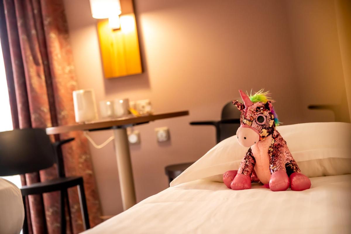 Un ou plusieurs lits dans un hébergement de l'établissement Best Western Eden SPA