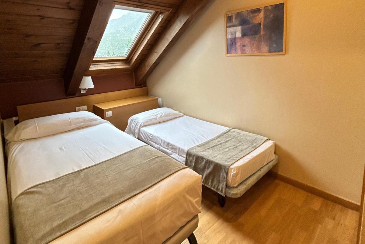 Cama o camas de una habitación en Aparthotel Siente Boí & SPA