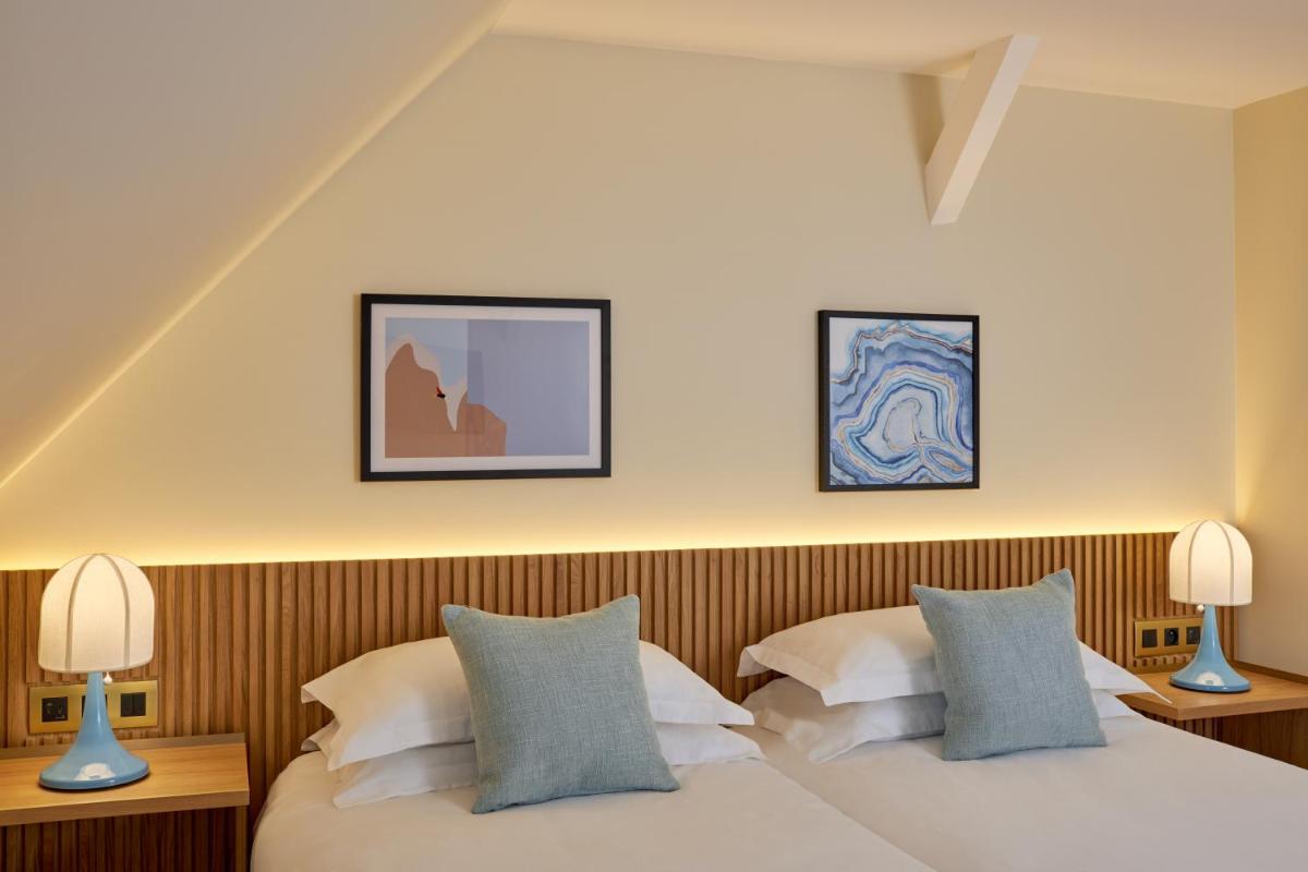 Un ou plusieurs lits dans un hébergement de l'établissement Castel Clara Thalasso & Spa