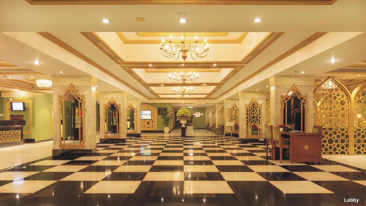 a lobby with a black and white checkered floor at Hotel Clarks Shiraz in Agra
