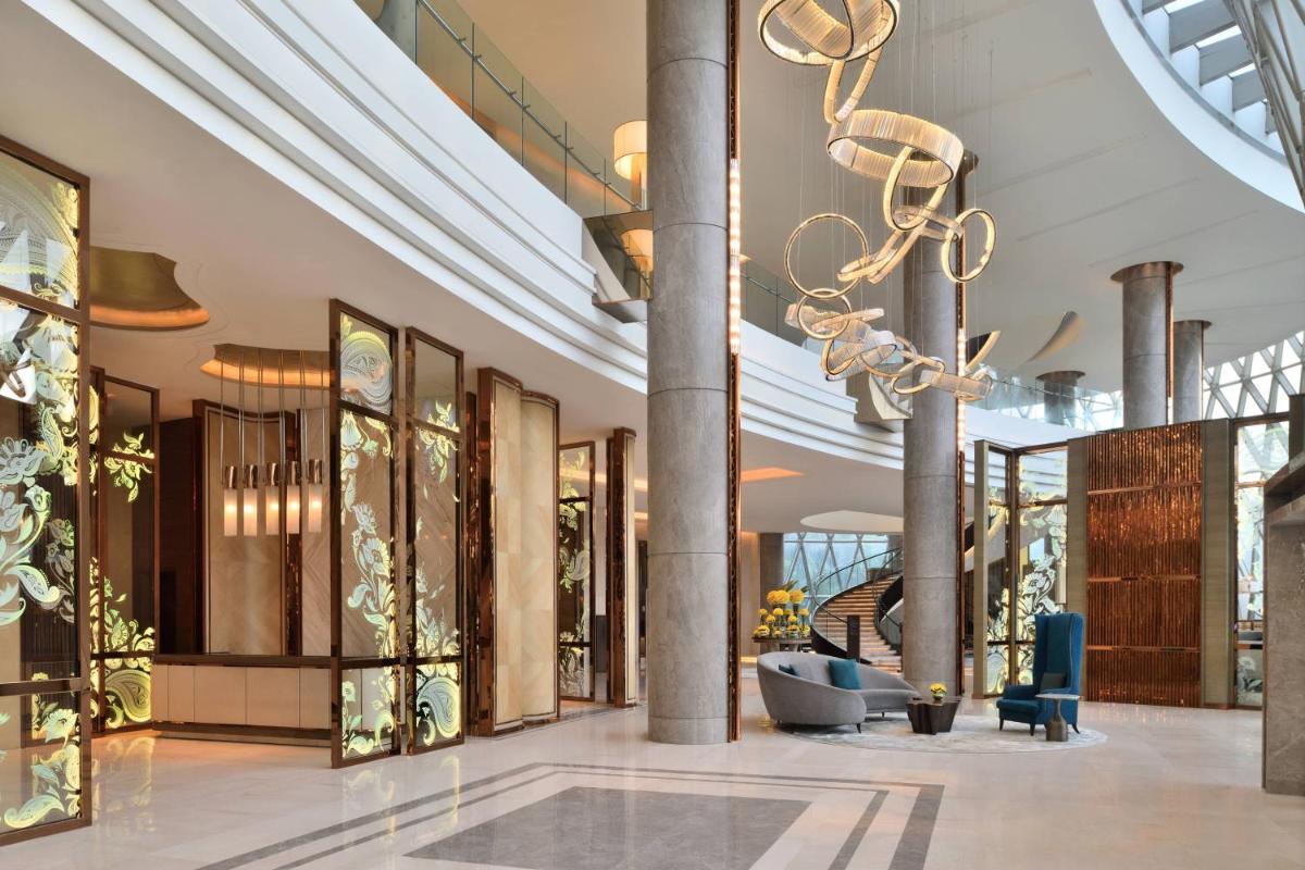 a lobby of a building with a chandelier at JW Marriott Hotel Kolkata in Kolkata