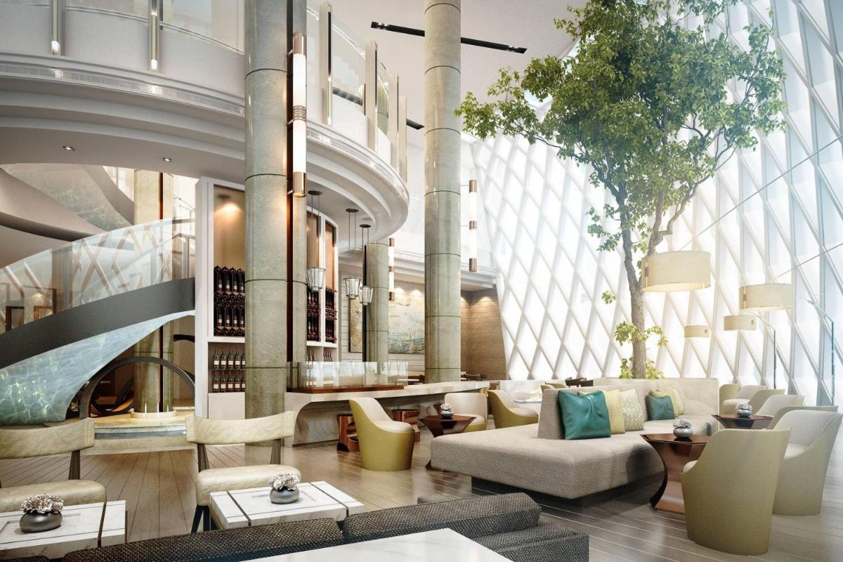 a lobby with couches and tables in a building at JW Marriott Hotel Kolkata in Kolkata