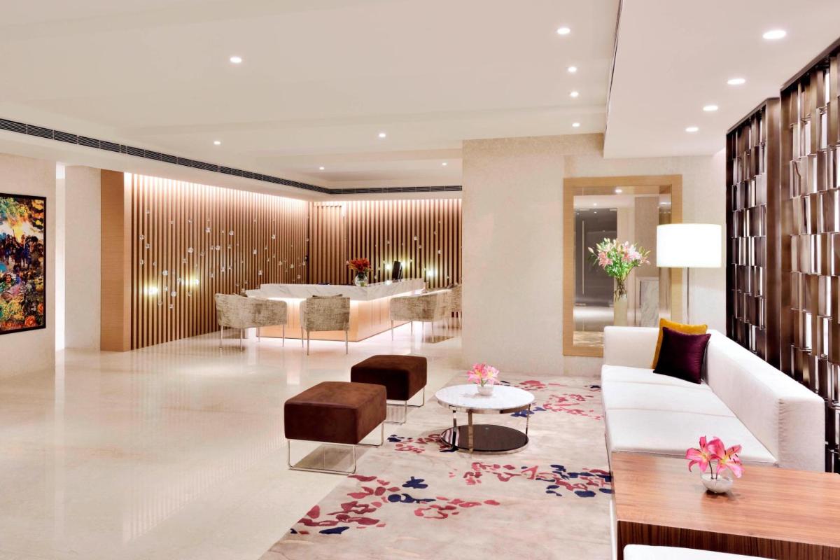 a living room with a couch and a table at Marriott Executive Apartments Hyderabad in Hyderabad