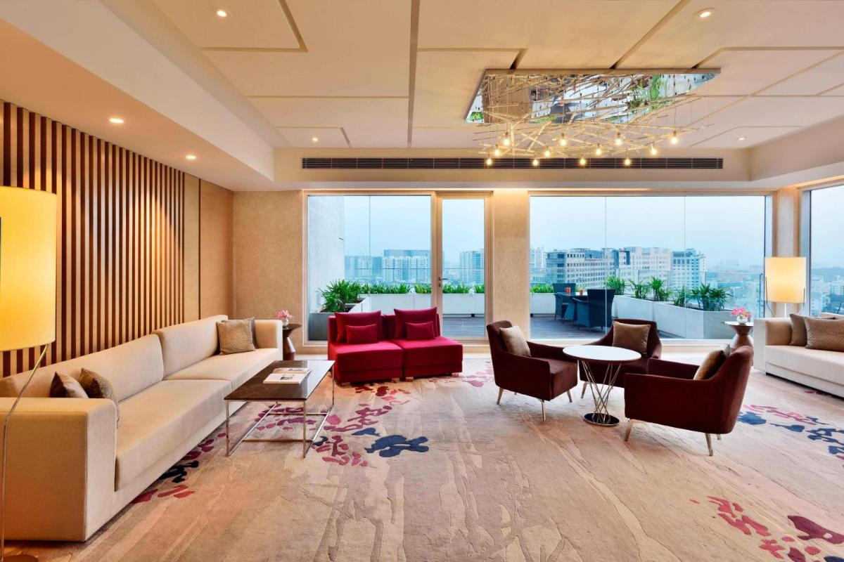 a living room with a couch and a table at Marriott Executive Apartments Hyderabad in Hyderabad