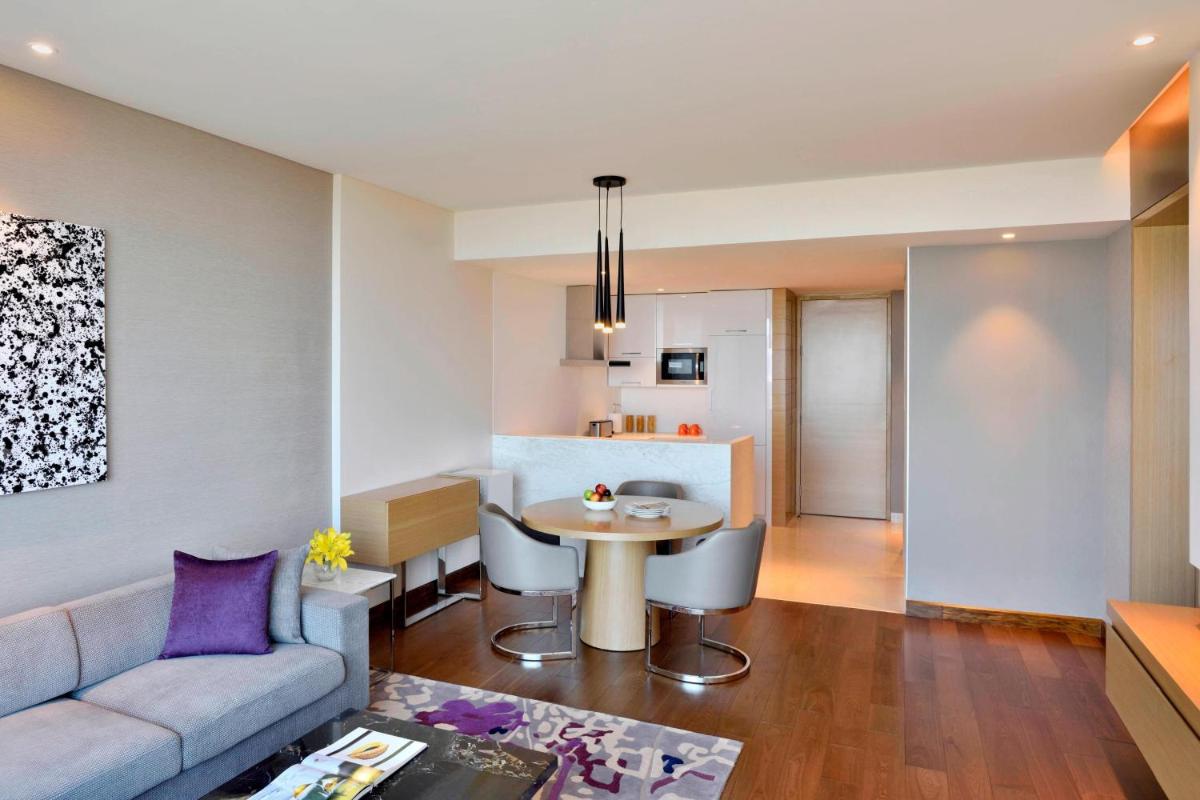 a living room with a couch and a table at Marriott Executive Apartments Hyderabad in Hyderabad