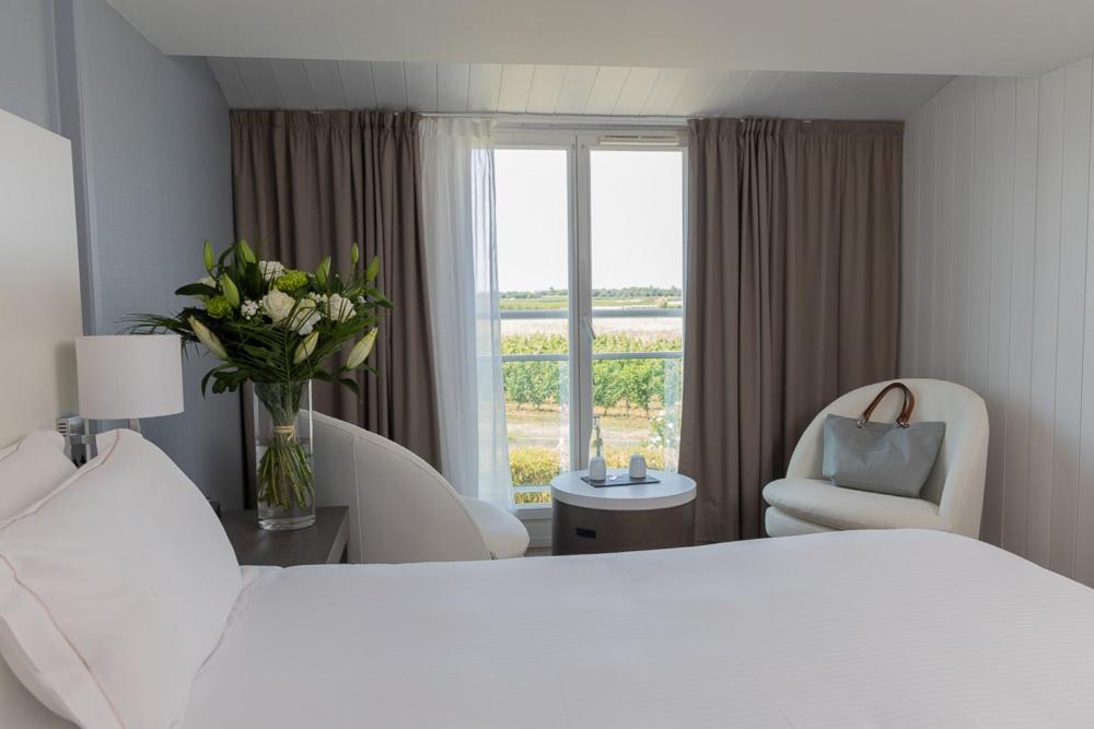 Un ou plusieurs lits dans un hébergement de l'établissement Hôtel Atalante - Relais Thalasso & Spa