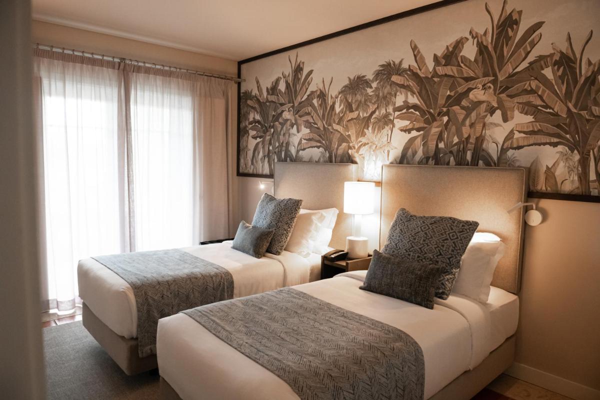 Uma cama ou camas num quarto em Domes Lake Algarve, Autograph Collection