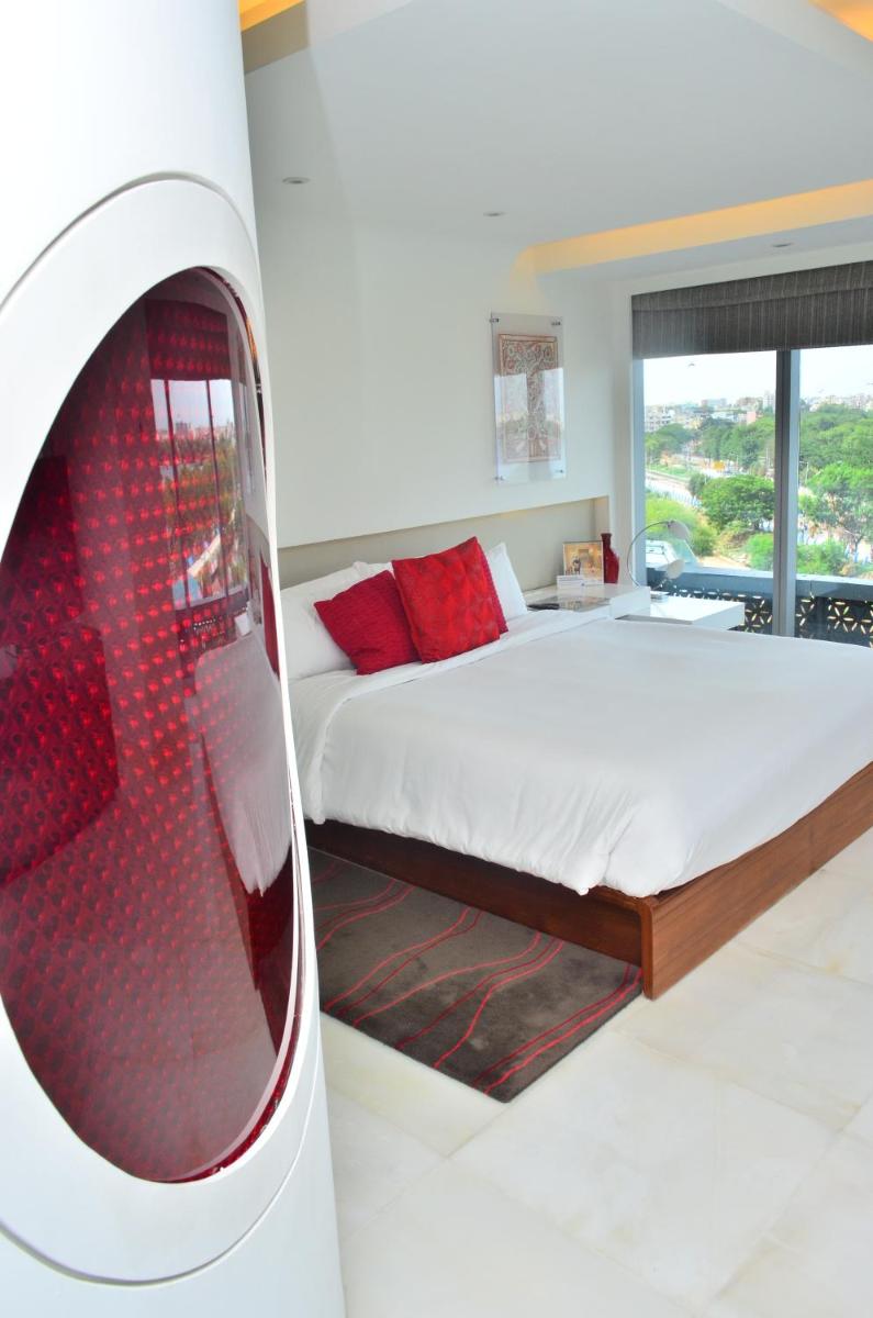 a white bedroom with a bed and a window at The Park Hyderabad, Banjara Hills near Hussain Sagar Lake in Hyderabad a white bedroom with a bed and a window at The Park Hyderabad, Banjara Hills near Hussain Sagar Lake in Hyderabad