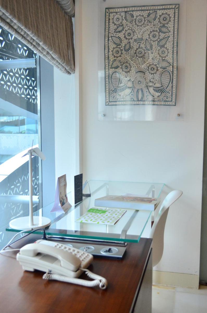 a glass desk with a phone on top of it at The Park Hyderabad, Banjara Hills near Hussain Sagar Lake in Hyderabad a glass desk with a phone on top of it at The Park Hyderabad, Banjara Hills near Hussain Sagar Lake in Hyderabad