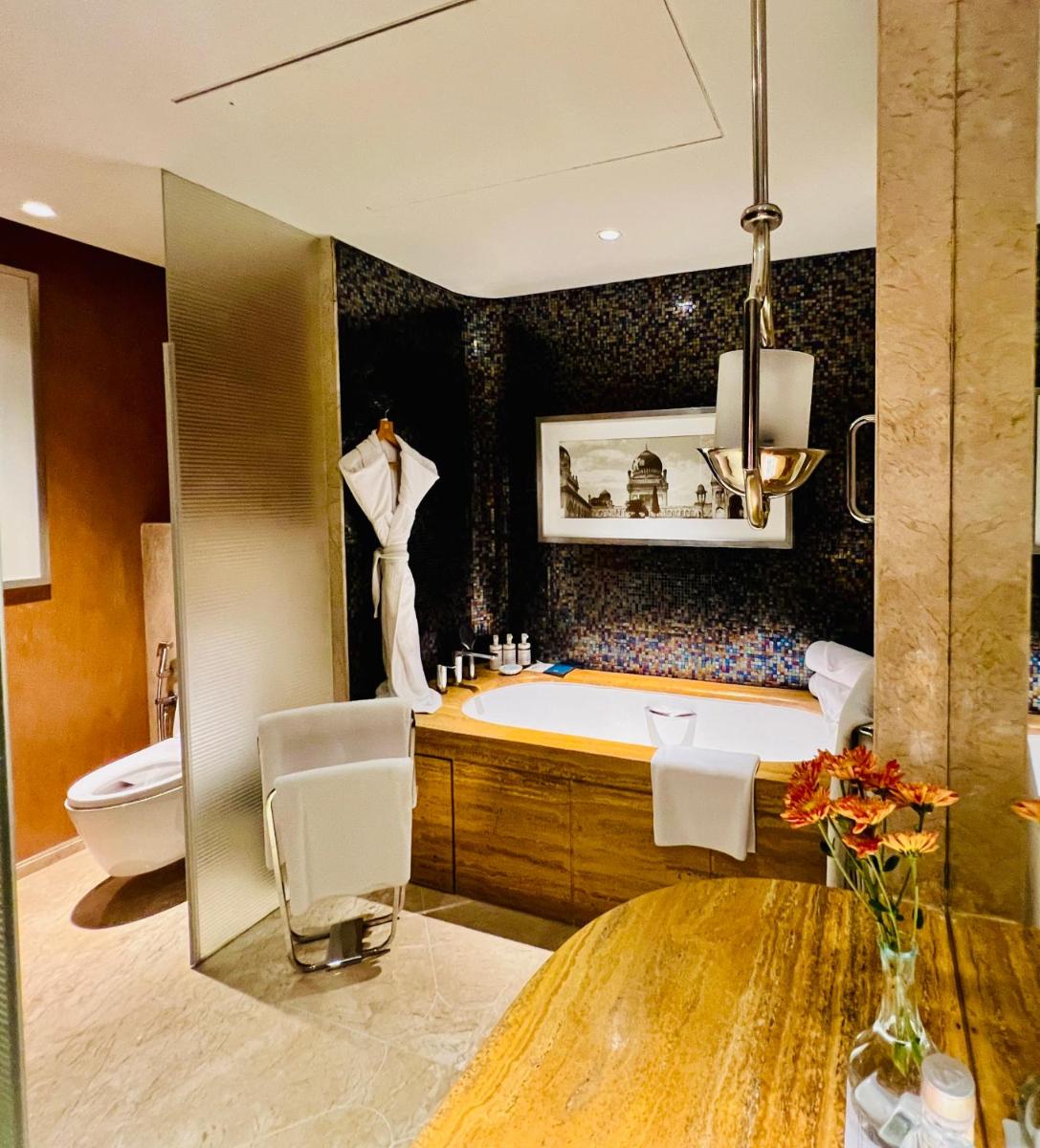 a large bathroom with a tub and a toilet at ITC Kohenur, a Luxury Collection Hotel, Hyderabad in Hyderabad