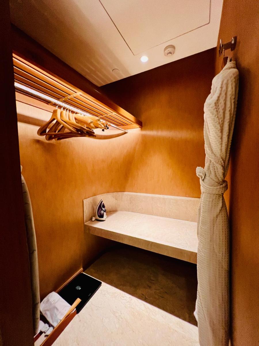 a room with a bench in the corner of a room at ITC Kohenur, a Luxury Collection Hotel, Hyderabad in Hyderabad