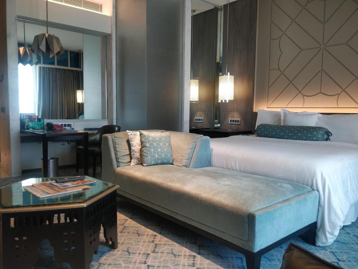a hotel room with a bed and a couch at ITC Kohenur, a Luxury Collection Hotel, Hyderabad in Hyderabad