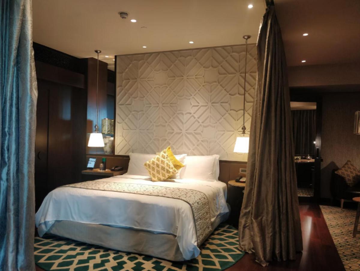 a hotel room with a bed and a canopy at ITC Kohenur, a Luxury Collection Hotel, Hyderabad in Hyderabad