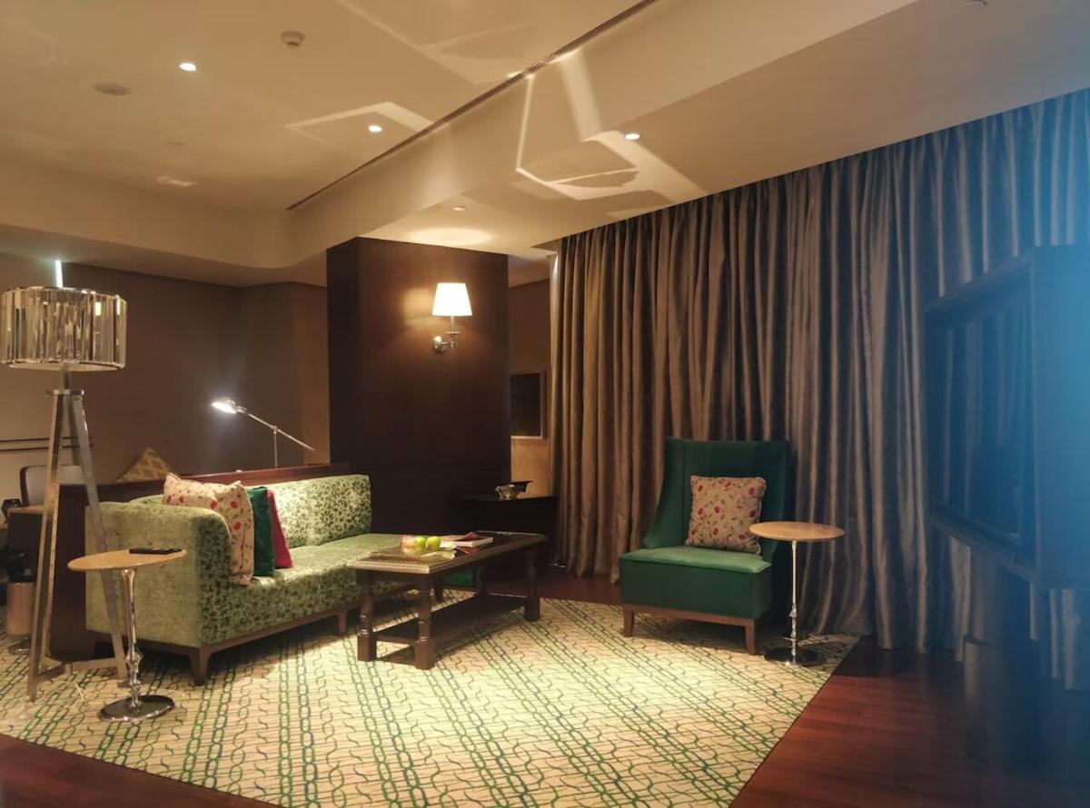 a living room with a couch and two chairs at ITC Kohenur, a Luxury Collection Hotel, Hyderabad in Hyderabad