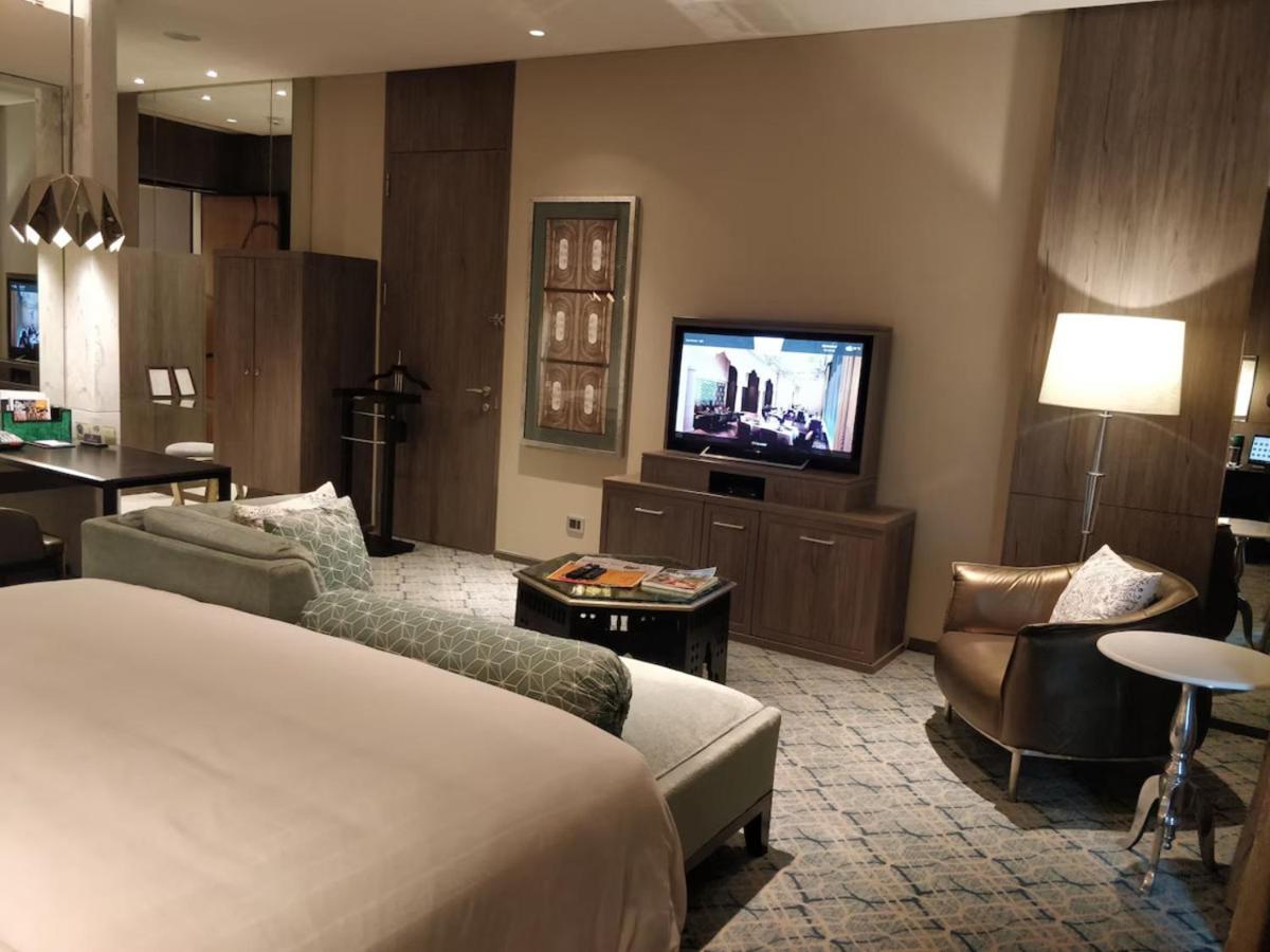 a hotel room with a bed and a flat screen tv at ITC Kohenur, a Luxury Collection Hotel, Hyderabad in Hyderabad