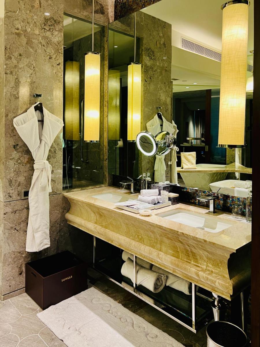 a bathroom with a sink and a large mirror at ITC Kohenur, a Luxury Collection Hotel, Hyderabad in Hyderabad