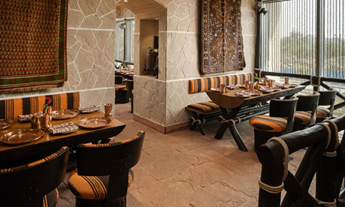 a restaurant with tables and chairs in a room at ITC Kohenur, a Luxury Collection Hotel, Hyderabad in Hyderabad