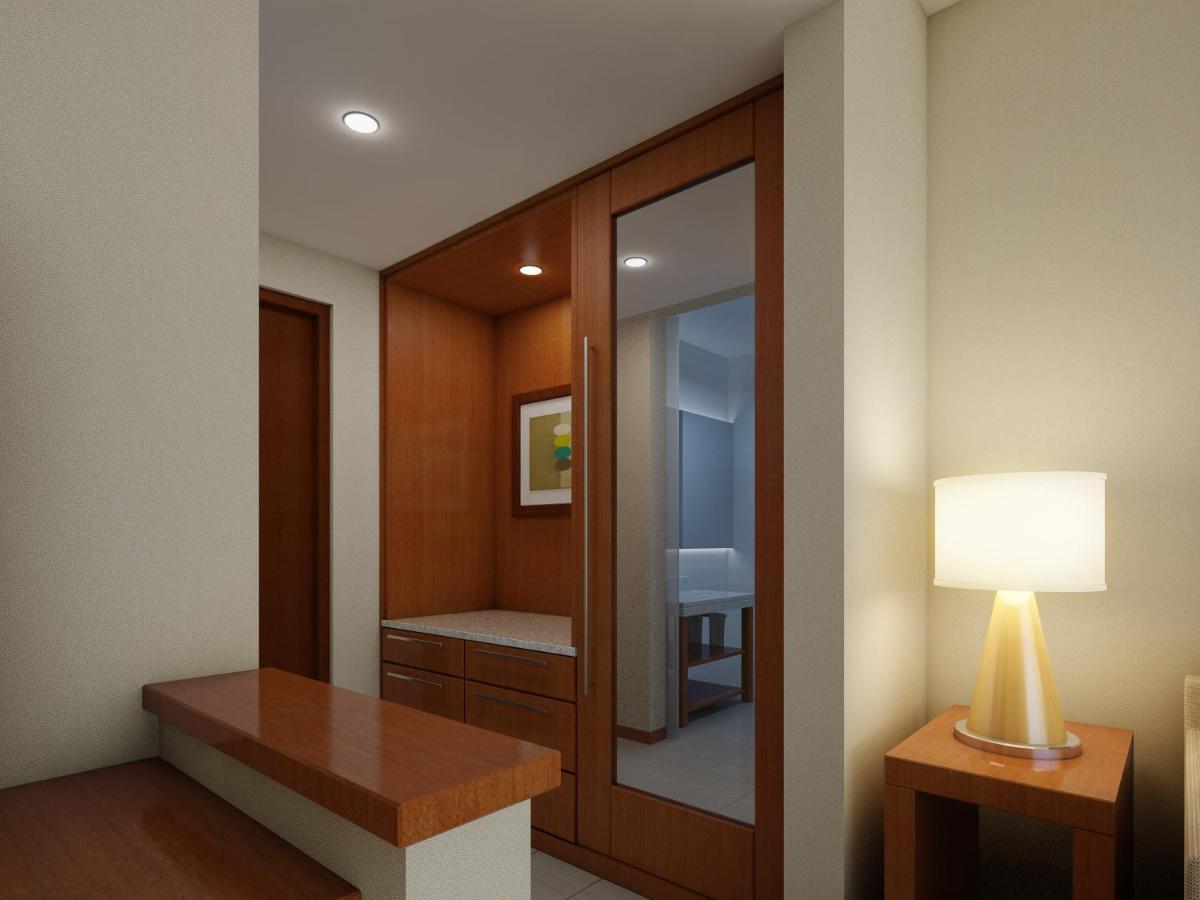 a dressing room with a mirror and a lamp at Hyatt Place Pune Hinjawadi in Pune