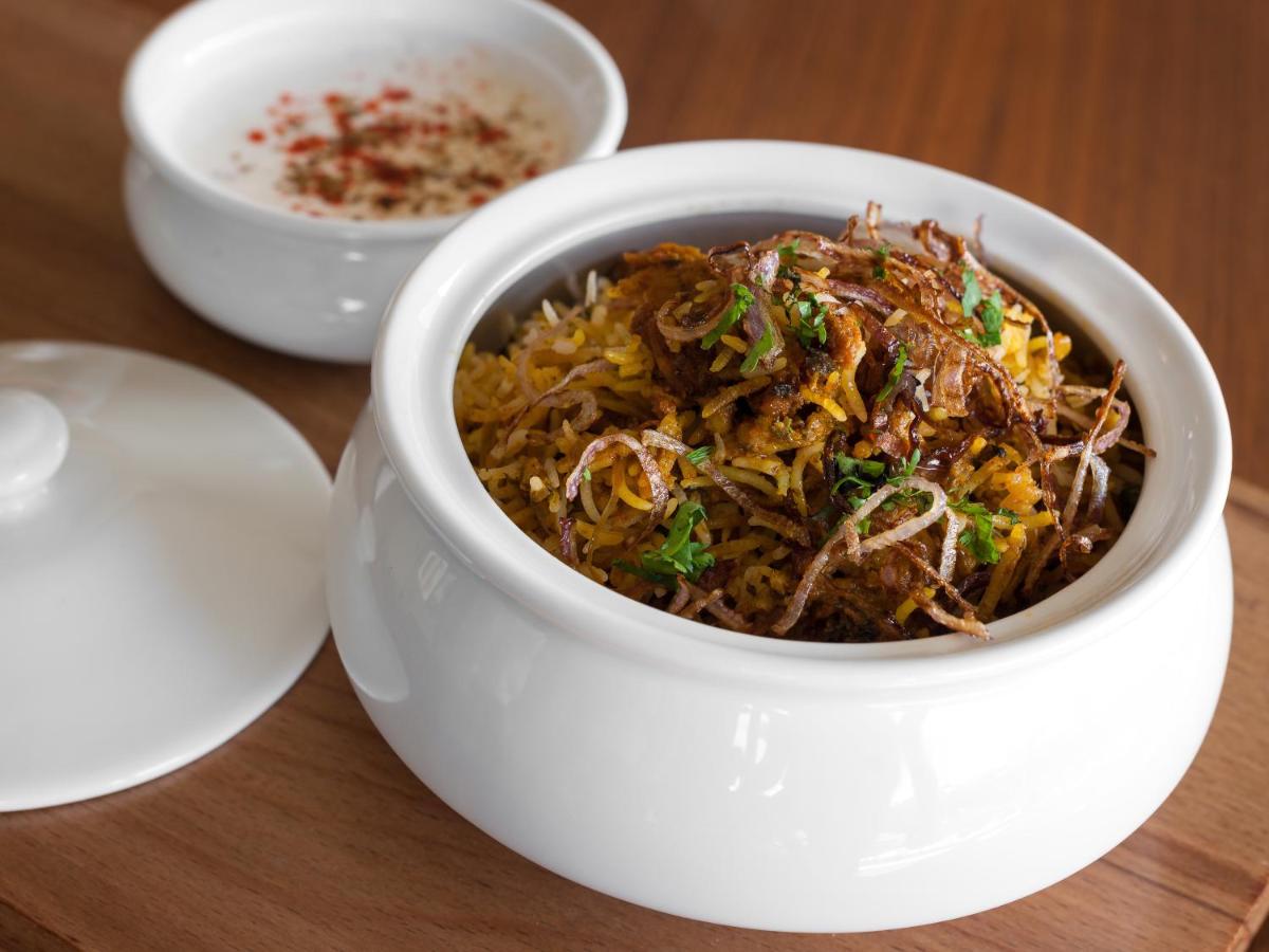 a white bowl of food on a table at Hyatt Place Pune Hinjawadi in Pune