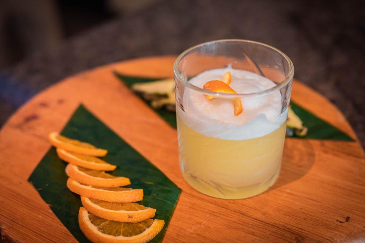 a glass of orange juice next to a plate of food at Hyatt Place Pune Hinjawadi in Pune