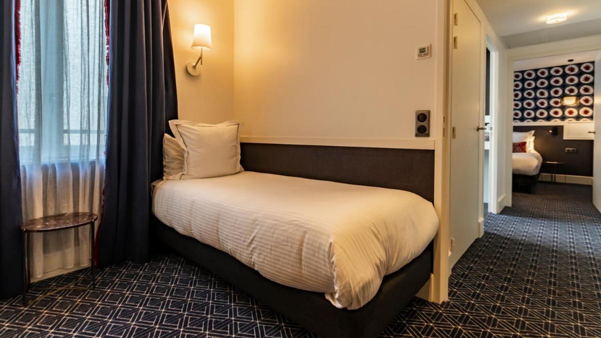 Un ou plusieurs lits dans un hébergement de l'établissement Continental Hotel