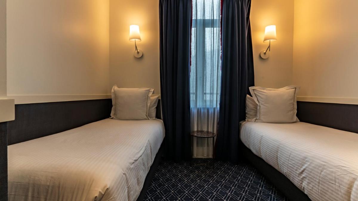 Un ou plusieurs lits dans un hébergement de l'établissement Continental Hotel