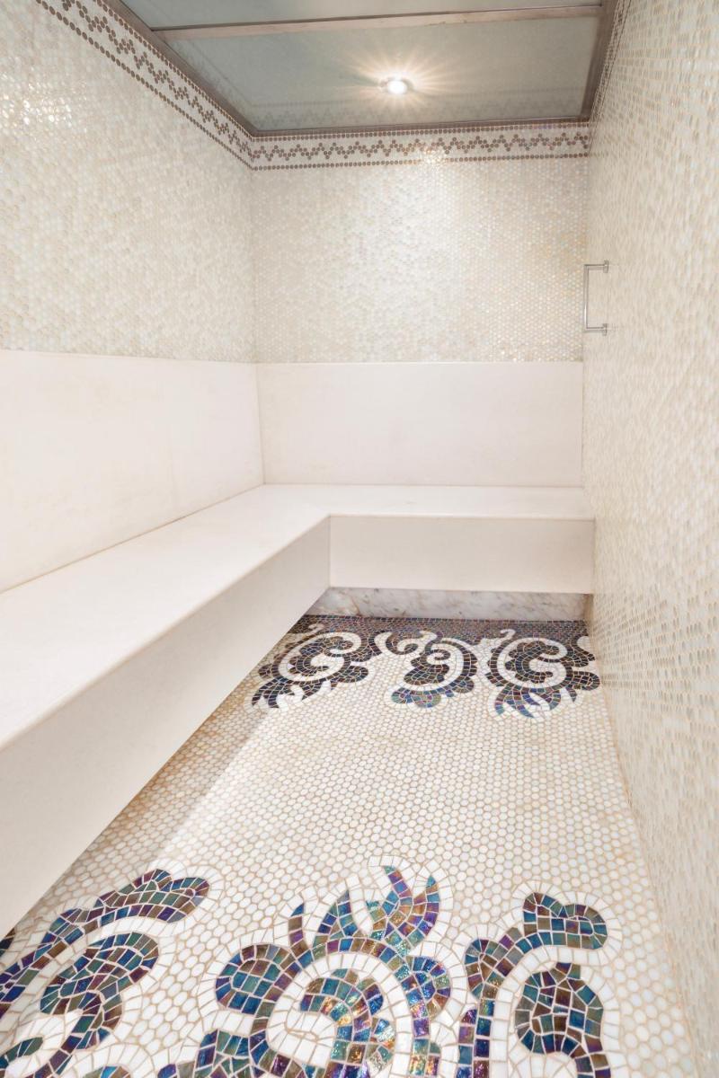 a bathroom with a tiled floor with a bath tub at Taj Palace, New Delhi in New Delhi a bathroom with a tiled floor with a bath tub at Taj Palace, New Delhi in New Delhi