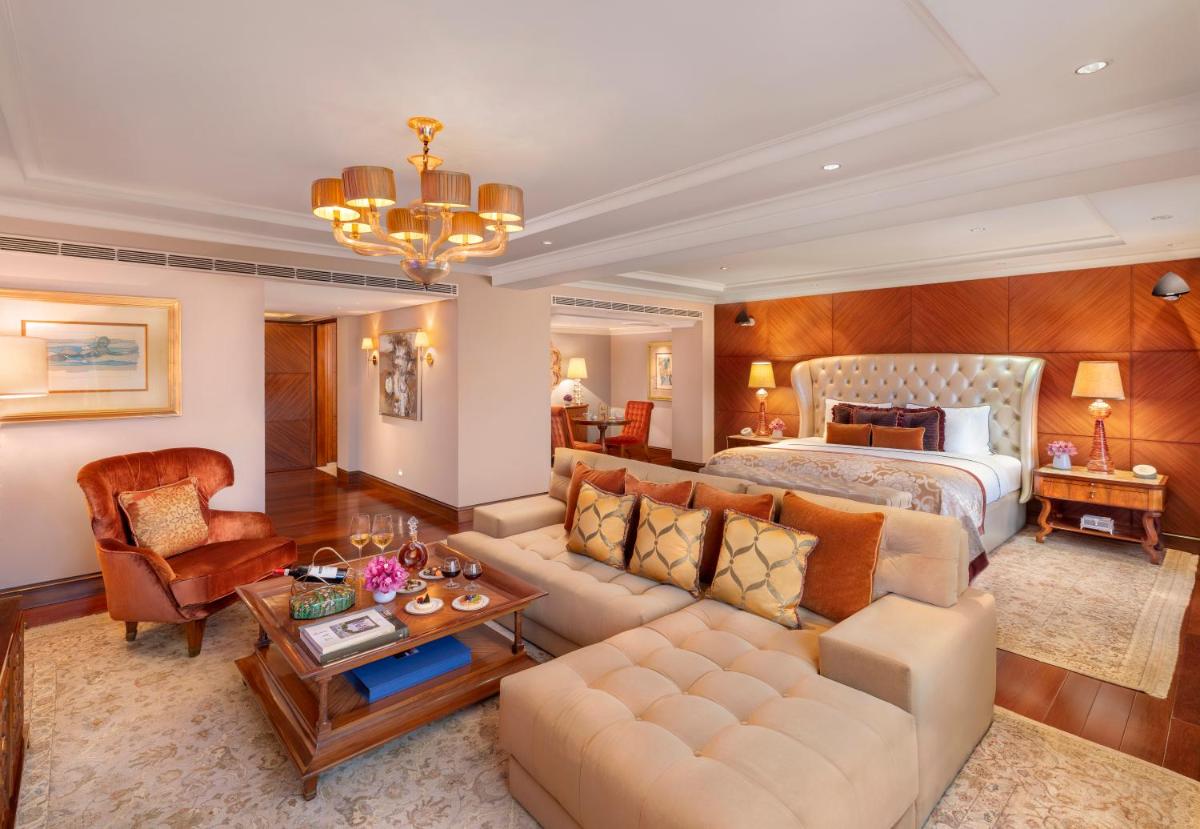 a bedroom with a bed and a living room at Taj Palace, New Delhi in New Delhi a bedroom with a bed and a living room at Taj Palace, New Delhi in New Delhi