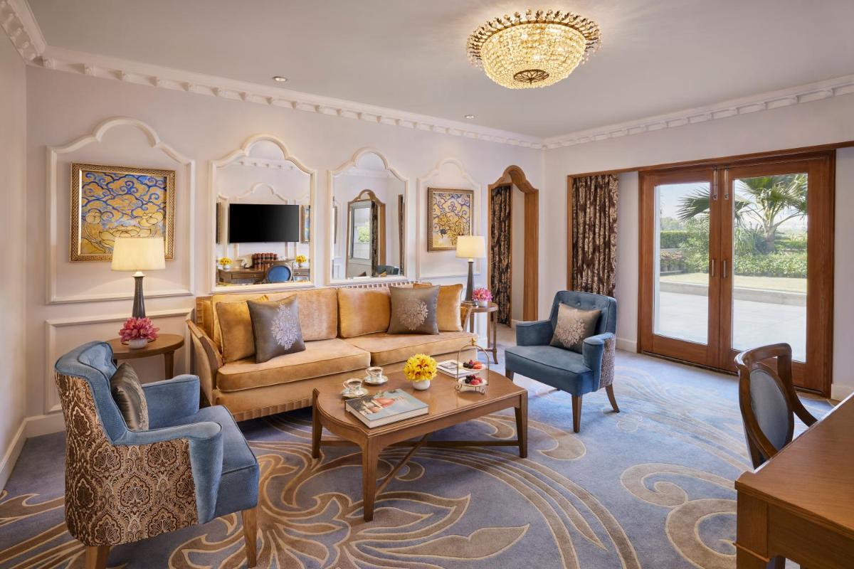 a living room with a couch and two chairs at Taj Palace, New Delhi in New Delhi a living room with a couch and two chairs at Taj Palace, New Delhi in New Delhi