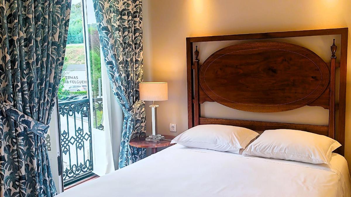 Uma cama ou camas num quarto em Grande Hotel das Caldas da Felgueira