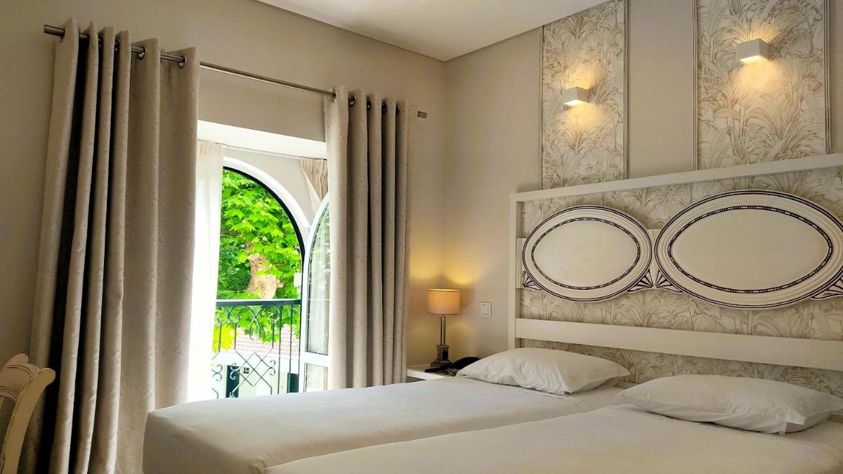 Uma cama ou camas num quarto em Grande Hotel das Caldas da Felgueira