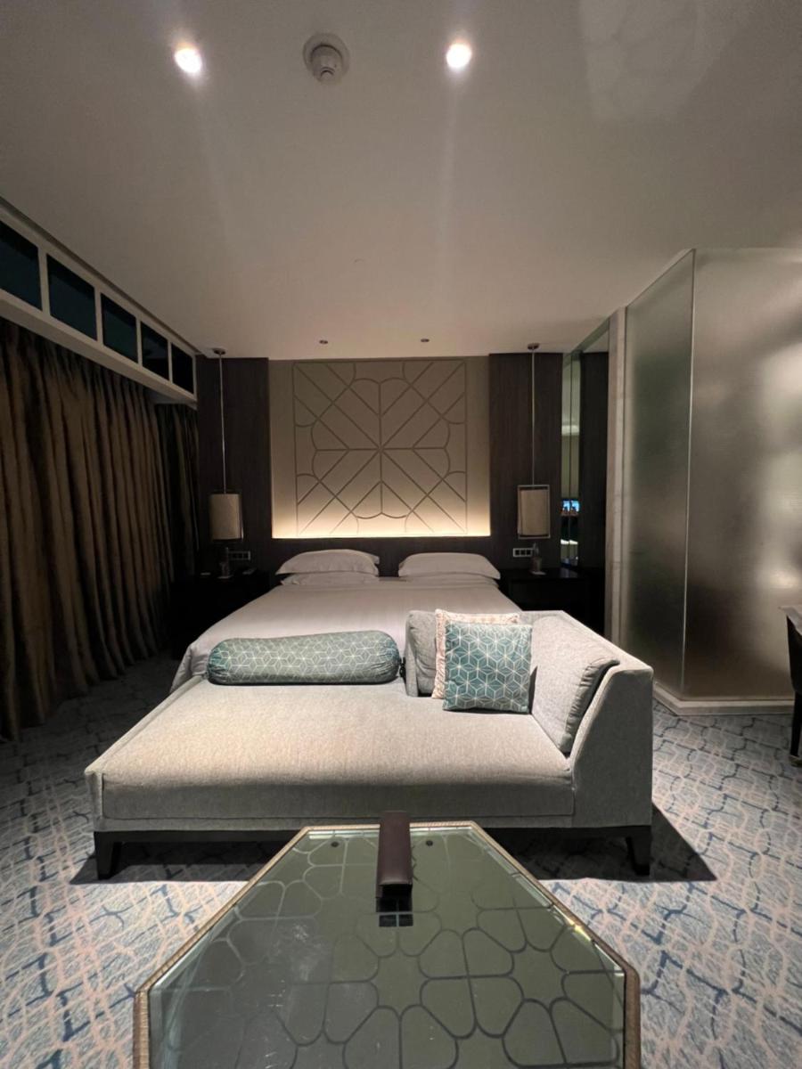 a large bedroom with a bed and a glass table at ITC Kohenur, a Luxury Collection Hotel, Hyderabad in Hyderabad