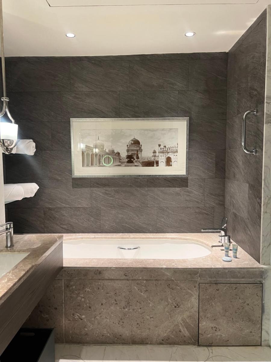 a bathroom with a tub and a picture on the wall at ITC Kohenur, a Luxury Collection Hotel, Hyderabad in Hyderabad