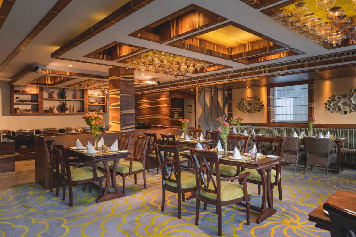 a dining room with wooden tables and chairs at Welcomhotel by ITC Hotels, Shimla in Shimla