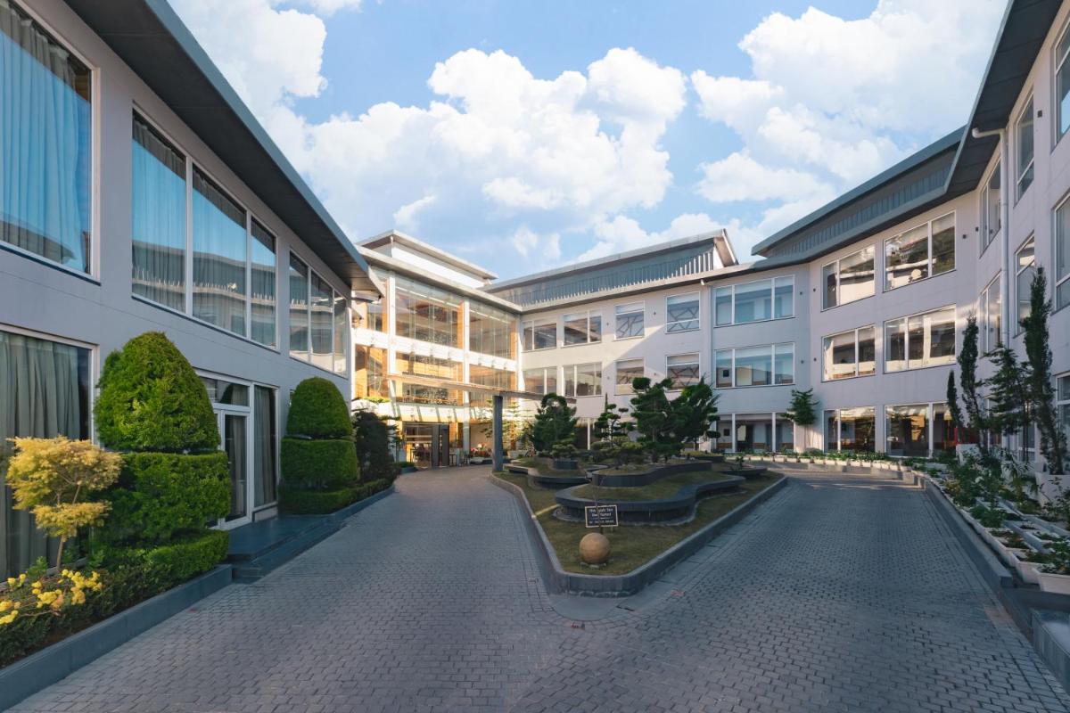 an external view of a building with a courtyard at Welcomhotel by ITC Hotels, Shimla in Shimla