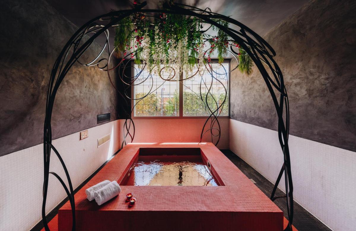 Un ou plusieurs lits dans un hébergement de l'établissement Hôtel Liberata & Spa