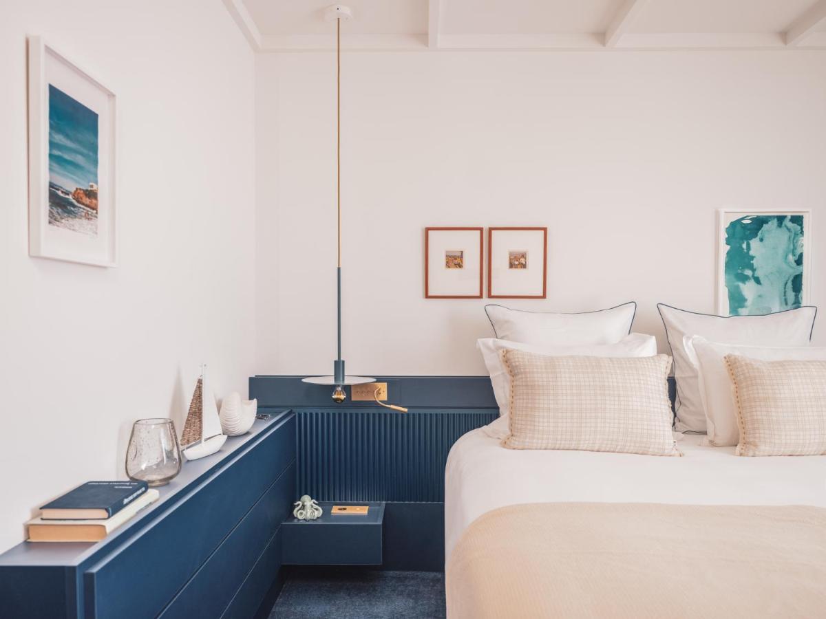 Un ou plusieurs lits dans un hébergement de l'établissement Bleu Hôtel & Spa