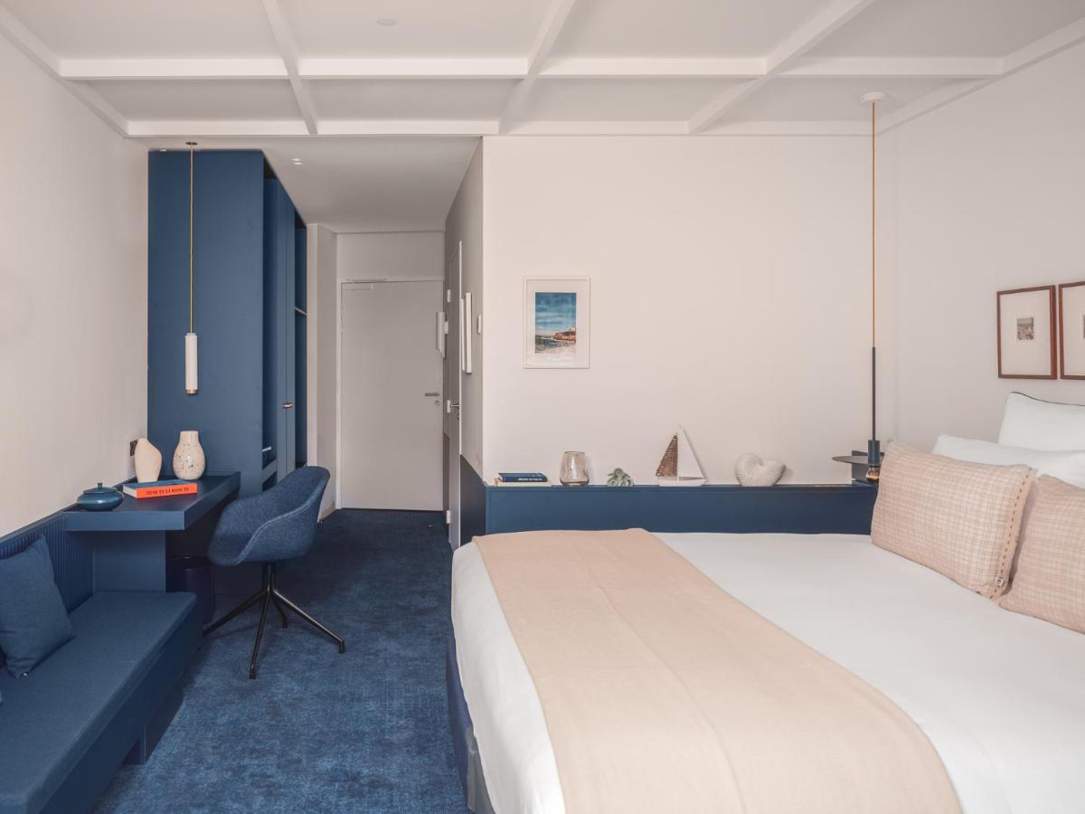 Un ou plusieurs lits dans un hébergement de l'établissement Bleu Hôtel & Spa