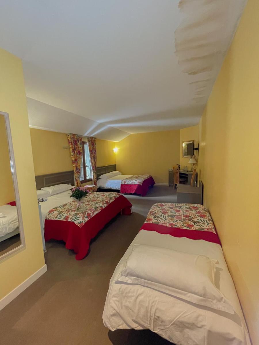 Un ou plusieurs lits dans un hébergement de l'établissement Maison Legate "Hôtel Le Baudiere & Spa"