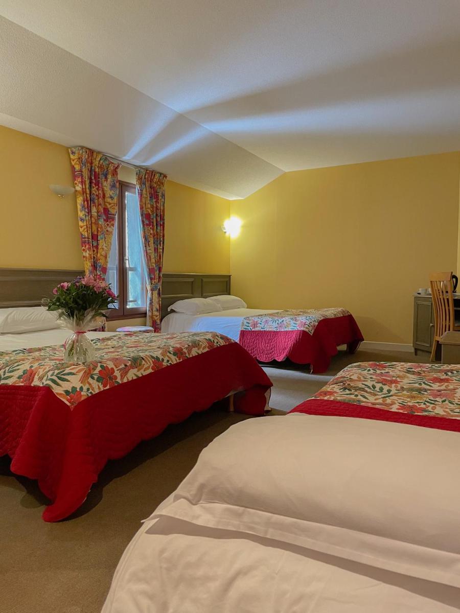 Un ou plusieurs lits dans un hébergement de l'établissement Maison Legate "Hôtel Le Baudiere & Spa"