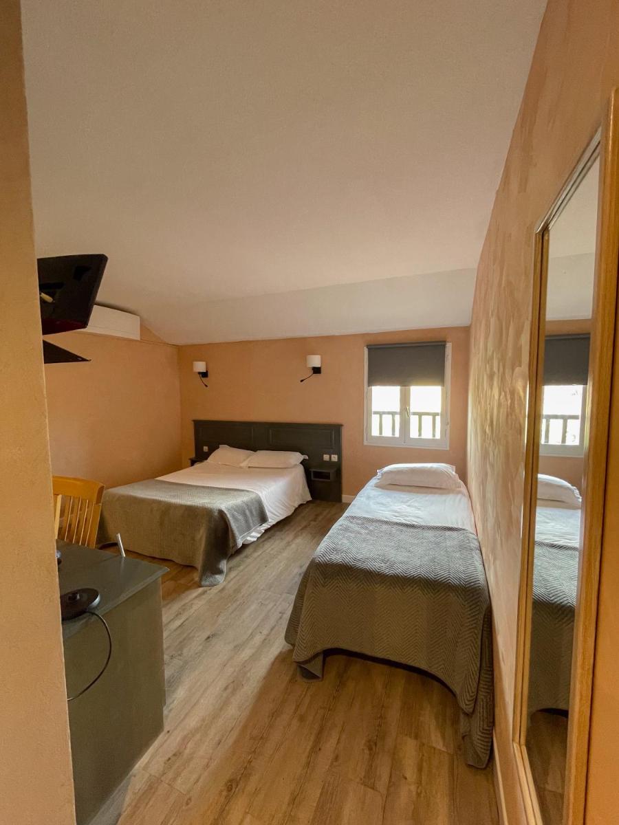 Un ou plusieurs lits dans un hébergement de l'établissement Maison Legate "Hôtel Le Baudiere & Spa"
