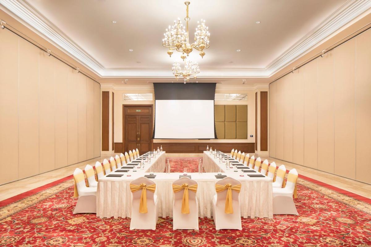 a conference room with a long table with bows at Taj Ganges Varanasi in Varanasi