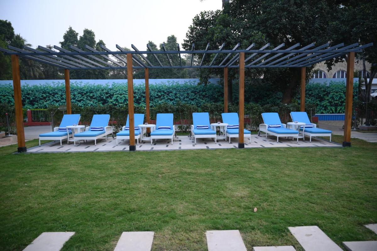 a group of blue chairs sitting on a patio at Taj Ganges Varanasi in Varanasi