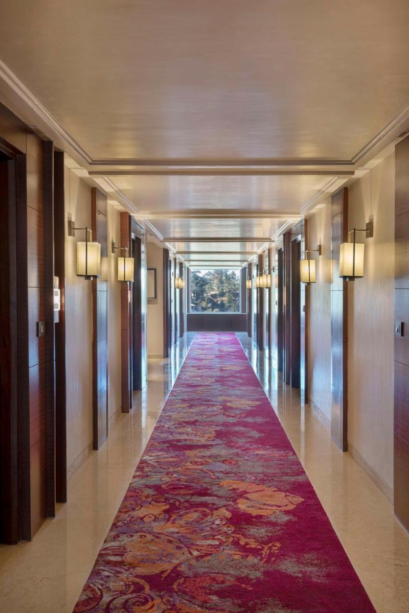 a long hallway with a red carpet in a building at Radisson Kufri in Shimla