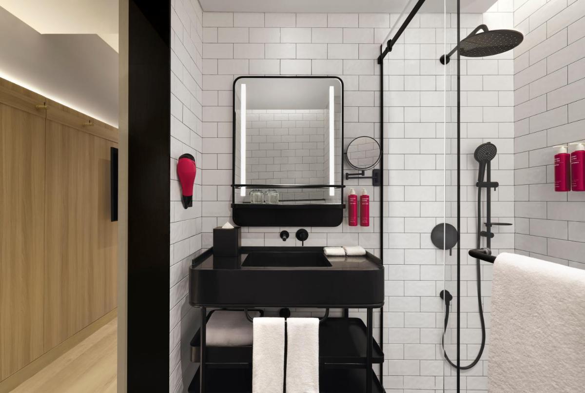 a bathroom with a black sink and a mirror at Moxy Mumbai Andheri West in Mumbai