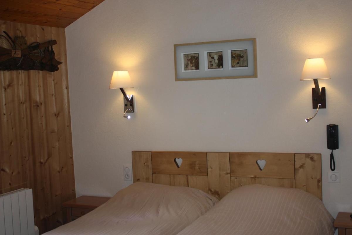 Un ou plusieurs lits dans un hébergement de l'établissement Logis Hotel Gai Soleil