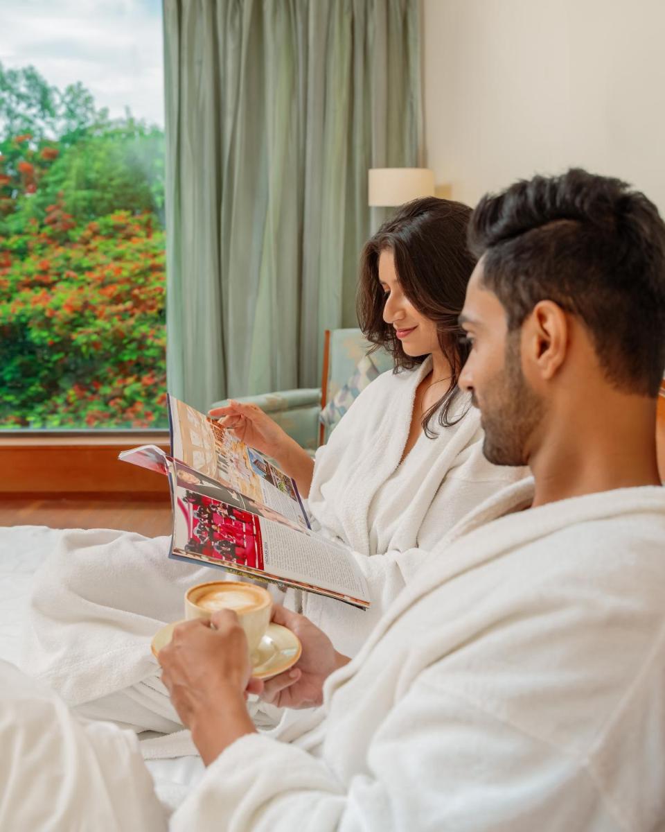 a group of people sitting in bed reading books at Hyatt Pune in Pune